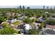 An aerial view shows the house nestled among lush greenery, with a city skyline in the distance at 3604 W El Prado Blvd, Tampa, FL 33629