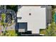 Aerial view of the modern, flat roof of this home with walkway, landscape, and pool cage at 3604 W El Prado Blvd, Tampa, FL 33629