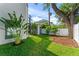 Serene backyard with manicured lawn, lush greenery, and modern architectural features including a fence at 3604 W El Prado Blvd, Tampa, FL 33629