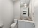 Modern powder room features a decorative sink, marble countertop, and elegant lighting at 3604 W El Prado Blvd, Tampa, FL 33629