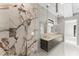 Modern bathroom featuring marble shower, double sink vanity, marble countertops, and pendant lighting at 3604 W El Prado Blvd, Tampa, FL 33629