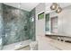 Sleek bathroom featuring glass shower with marble tile and modern fixtures at 3604 W El Prado Blvd, Tampa, FL 33629