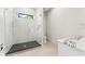 Bathroom features a glass enclosed shower with marble tile, black floor, and white marble countertop at 3604 W El Prado Blvd, Tampa, FL 33629