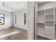 Bedroom leading to organized walk-in closet features shelving and drawers for storage at 3604 W El Prado Blvd, Tampa, FL 33629