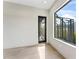 Bright bedroom with hardwood floors, modern windows, and a black door at 3604 W El Prado Blvd, Tampa, FL 33629