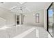 Spacious bedroom with tray ceilings, modern lighting, and large windows offering ample light at 3604 W El Prado Blvd, Tampa, FL 33629