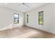 Bright bedroom boasts wood floors, neutral walls, modern ceiling fan, and three beautiful, large windows at 3604 W El Prado Blvd, Tampa, FL 33629
