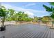 Spacious deck with metal railing offering views of lush greenery and the surrounding neighborhood at 3604 W El Prado Blvd, Tampa, FL 33629