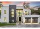 A modern two-story house showcases clean lines, a balcony, and a well-maintained front yard at 3604 W El Prado Blvd, Tampa, FL 33629