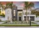 Contemporary two-story home boasting modern design elements, a balcony, and meticulously landscaped front yard at 3604 W El Prado Blvd, Tampa, FL 33629