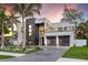 Striking modern home with a two-car garage, balcony, and tastefully landscaped front yard at 3604 W El Prado Blvd, Tampa, FL 33629