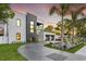 Modern two-story home featuring a sleek design, gray accent wall, balcony, and a spacious two-car garage at 3604 W El Prado Blvd, Tampa, FL 33629