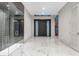 View of the foyer with glass enclosed wine cellar and marble floors at 3604 W El Prado Blvd, Tampa, FL 33629