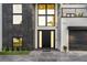 Modern home with a sleek front door, well-lit entry, and neatly manicured landscaping at 3604 W El Prado Blvd, Tampa, FL 33629