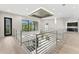 Bright hallway with railings, windows, recessed lighting, and hardwood floors at 3604 W El Prado Blvd, Tampa, FL 33629