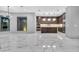 Modern kitchen with dark wood cabinetry, marble countertops, and stainless steel appliances at 3604 W El Prado Blvd, Tampa, FL 33629