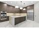 Modern kitchen with marble countertops, stainless steel appliances, and three pendant lights at 3604 W El Prado Blvd, Tampa, FL 33629
