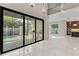 Living room featuring sliding glass doors to the outside patio and outdoor kitchen at 3604 W El Prado Blvd, Tampa, FL 33629