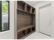Mudroom showcasing built-in bench, storage cubbies, and coat hooks providing organization at 3604 W El Prado Blvd, Tampa, FL 33629