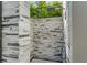 Stylish outdoor shower featuring decorative stone walls and modern fixtures surrounded by greenery at 3604 W El Prado Blvd, Tampa, FL 33629