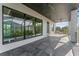 Large patio with grey stone flooring, ceiling fans, and gorgeous exterior views from its many windows at 3604 W El Prado Blvd, Tampa, FL 33629