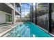 Beautiful pool surrounded by a screened-in enclosure, providing a luxurious outdoor living space at 3604 W El Prado Blvd, Tampa, FL 33629