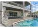 A covered lanai with an outdoor kitchen area and a beautiful swimming pool at 3604 W El Prado Blvd, Tampa, FL 33629