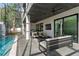 Inviting poolside patio with comfortable seating, outdoor TV, and a screened-in pool area at 3604 W El Prado Blvd, Tampa, FL 33629