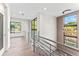 Modern staircase features wood floors, metal railings, and large windows, providing plenty of light at 3604 W El Prado Blvd, Tampa, FL 33629