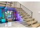 Modern staircase with floating wooden treads, metal railing, and a decorative water feature at 3604 W El Prado Blvd, Tampa, FL 33629