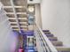 Unique staircase with floating steps, metal railings, and a view of the modern water feature at 3604 W El Prado Blvd, Tampa, FL 33629