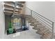 Contemporary staircase with wood treads, metal railings, and a unique water feature below at 3604 W El Prado Blvd, Tampa, FL 33629