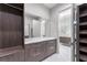 Spacious walk-in closet featuring custom drawers, shelving, and convenient access to the bathroom at 3604 W El Prado Blvd, Tampa, FL 33629