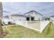 Expansive backyard featuring a white picket fence and lush green lawn for outdoor activities and enjoyment at 3706 Front Park Dr, Wesley Chapel, FL 33543