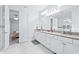 Contemporary bathroom with double vanity, shower, and view into the bedroom at 3706 Front Park Dr, Wesley Chapel, FL 33543