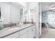 Well-lit bathroom featuring double sinks, quartz countertops, and framed mirrors with appealing nautical decor at 3706 Front Park Dr, Wesley Chapel, FL 33543