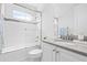 Clean bathroom featuring a shower-tub combination, granite countertops, and a gray tiled backsplash at 3706 Front Park Dr, Wesley Chapel, FL 33543