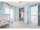 Light-filled ' bedroom with soft blue walls and an organized closet featuring built-in storage solutions at 3706 Front Park Dr, Wesley Chapel, FL 33543