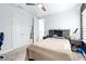 Bedroom with a ceiling fan, closet with open doors, and a decorative shelf display at 3706 Front Park Dr, Wesley Chapel, FL 33543