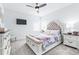 Bright bedroom featuring a decorative bed frame, a ceiling fan, and a mounted television at 3706 Front Park Dr, Wesley Chapel, FL 33543