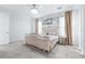Elegant bedroom featuring a tufted headboard, neutral colors, and natural light at 3706 Front Park Dr, Wesley Chapel, FL 33543