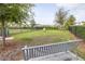 Community dog park with a bench and green lawn, perfect for pets to play and relax at 3706 Front Park Dr, Wesley Chapel, FL 33543