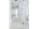 Hallway leading to bathroom with modern artwork, neutral decor and recessed lighting at 3706 Front Park Dr, Wesley Chapel, FL 33543