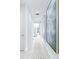 Bright hallway displays neutral decor, recessed lighting and modern artwork at 3706 Front Park Dr, Wesley Chapel, FL 33543