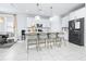 Bright kitchen showcasing island seating, modern lighting, and stainless steel appliances at 3706 Front Park Dr, Wesley Chapel, FL 33543