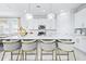 Modern kitchen boasts island seating, bright lighting, white cabinetry, and stainless appliances at 3706 Front Park Dr, Wesley Chapel, FL 33543