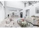 Open living area with white couches and kitchen featuring island and stainless steel appliances at 3706 Front Park Dr, Wesley Chapel, FL 33543