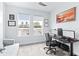 Well lit home office with multiple windows, carpeted floors, and a comfortable couch at 3706 Front Park Dr, Wesley Chapel, FL 33543