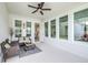 Charming screened porch featuring comfortable seating and an outdoor ceiling fan at 3706 Front Park Dr, Wesley Chapel, FL 33543
