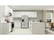 Bright kitchen featuring stainless steel appliances, white cabinetry, and an island with barstool seating at 3713 Forest Path Dr, Plant City, FL 33565